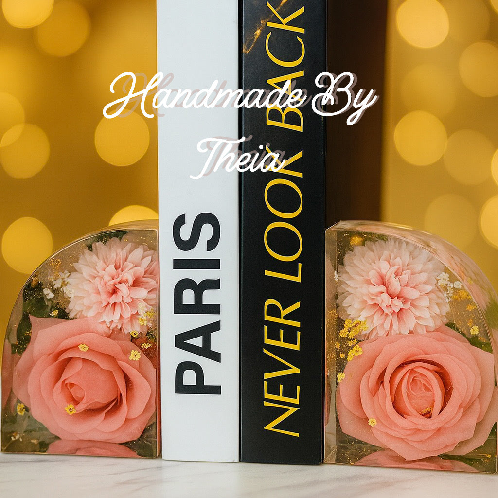 Decorative books with pink flowers on a blurred gold background, featuring 'PARIS' and 'Never Look Back'.