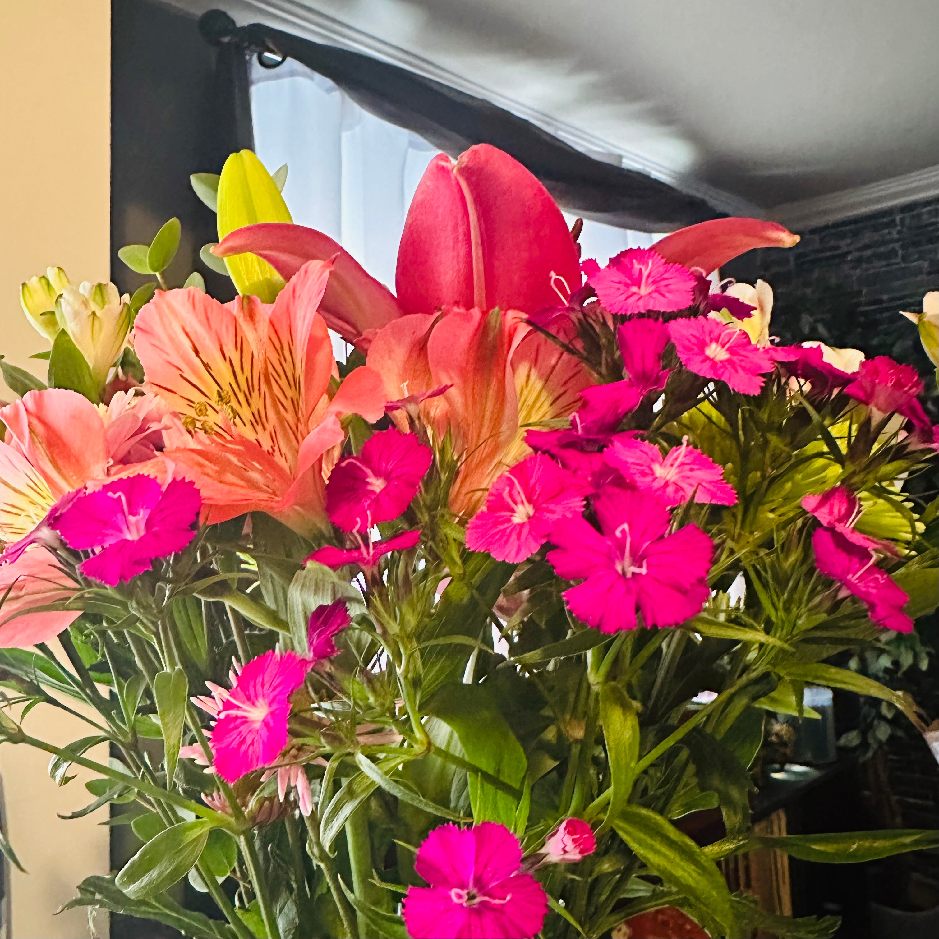 Bouquet of colorful flowers with pink, orange, and green hues.